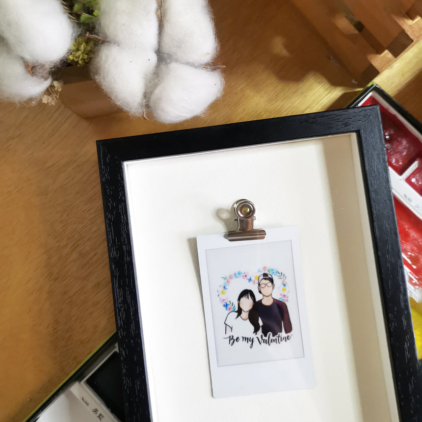 Portrait film in Mini size with clip in a black frame.