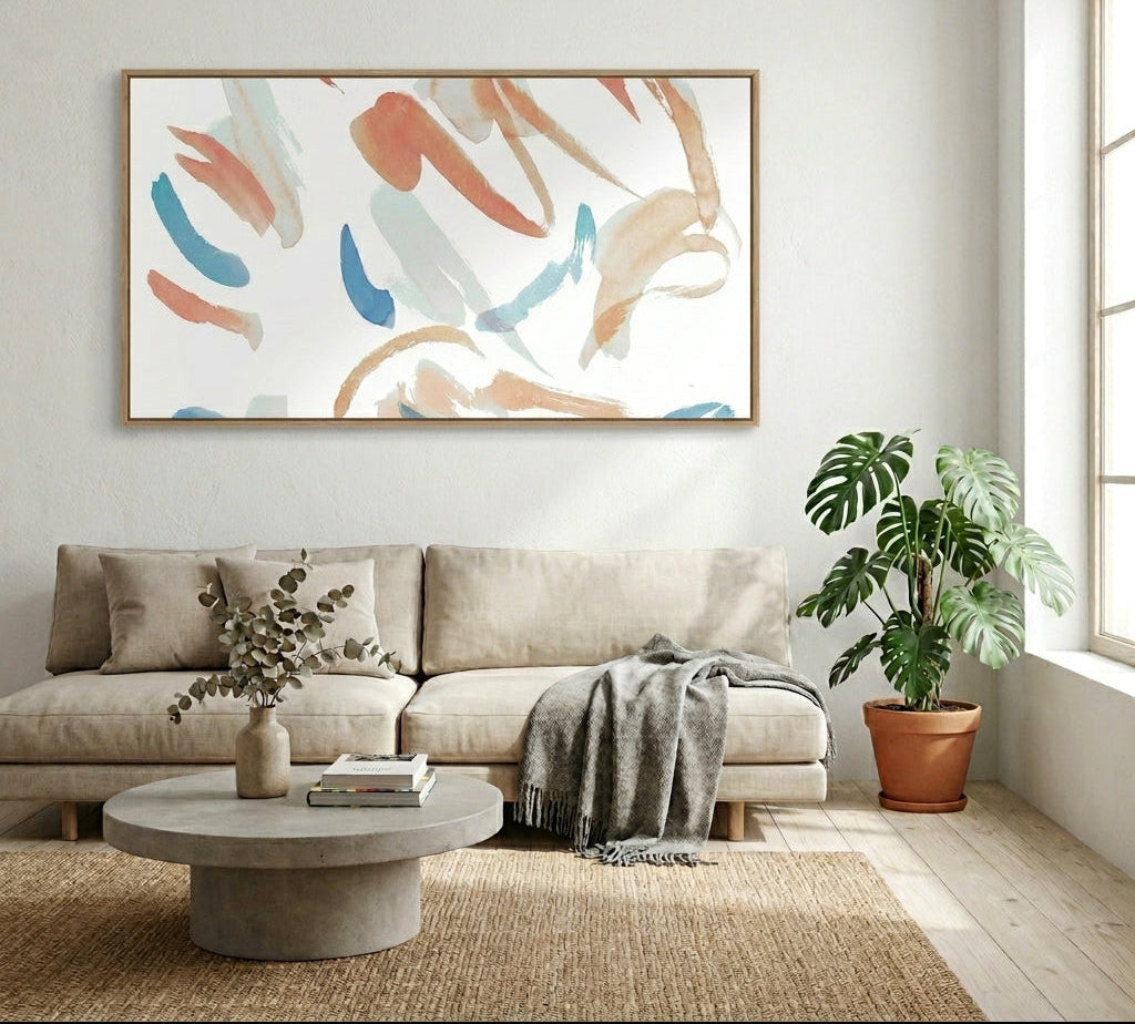 Living room with a beige sofa, abstract art, and plants