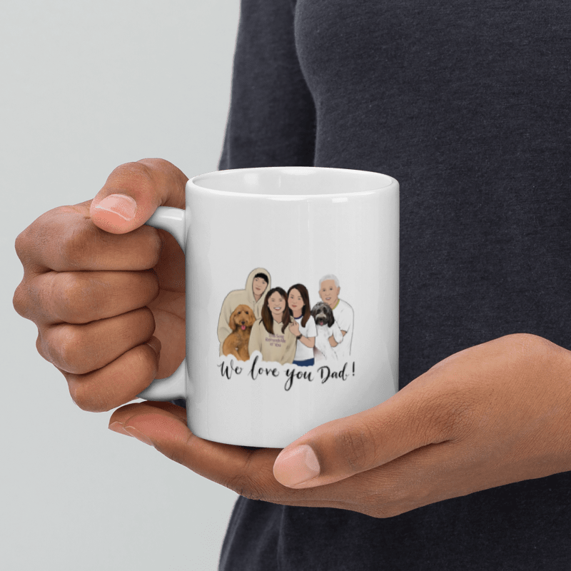 Person holding a white mug with a family and dog illustration and text.