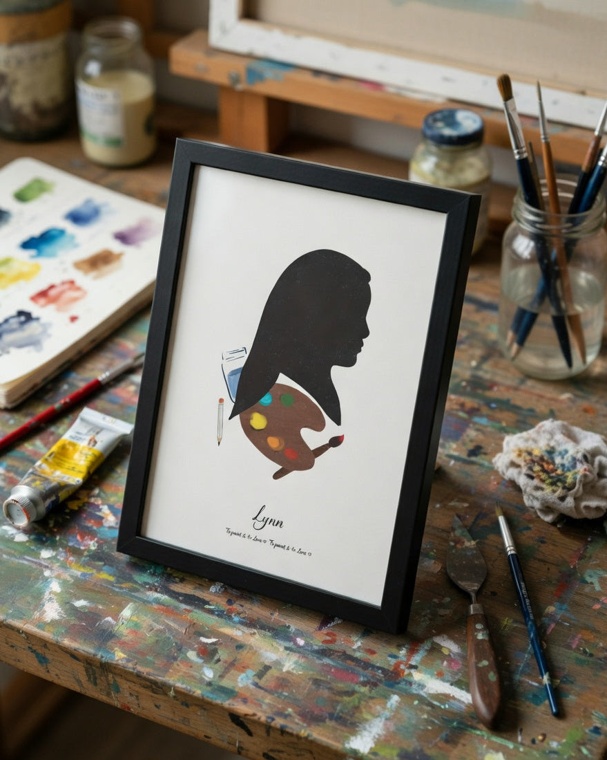 Framed silhouette art of a painter on an artist's worktable with paint supplies.