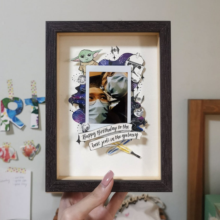Watercolor papercut star wars design with a couple photo in a dark brown frame.